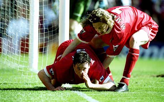 3 Apr 1999: Robbie Fowler of Liverpool is pulled away by team mate Steve McManaman after mimicking cocaine snorting to celebrate his first goal against Everton in the FA Carling Premiership match at Anfield in Liverpool, England. Liverpool won 3-2. Mandatory Credit: Ross Kinnaird /Allsport